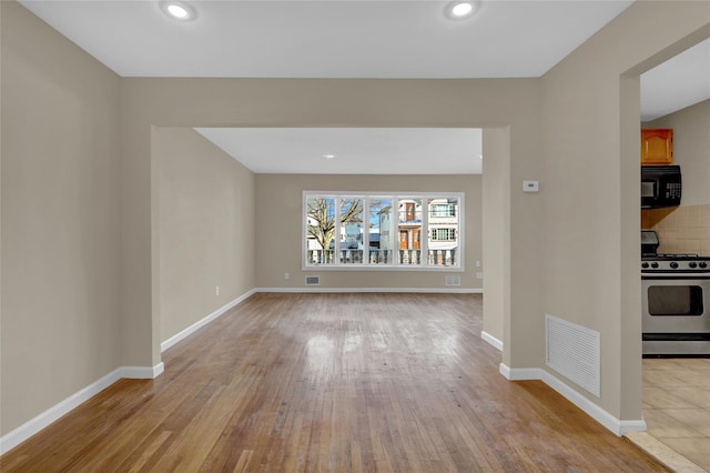 unfurnished living room featuring light hardwood / wood-style floors