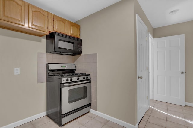 kitchen with tasteful backsplash, gas stove, light brown cabinets, and light tile patterned flooring