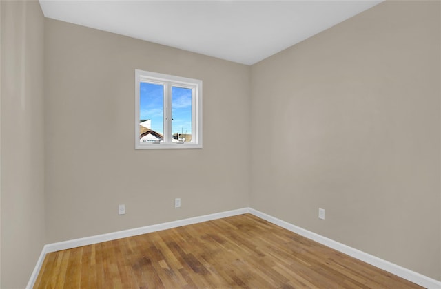 unfurnished room with hardwood / wood-style floors