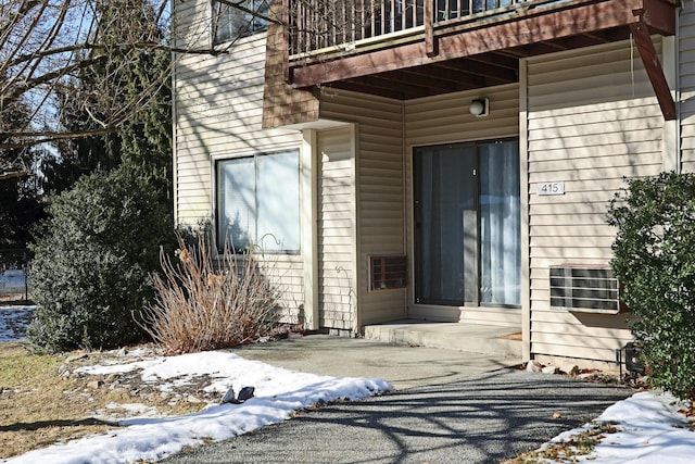 view of snow covered property entrance