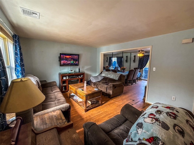 living room featuring hardwood / wood-style flooring, plenty of natural light, and ceiling fan