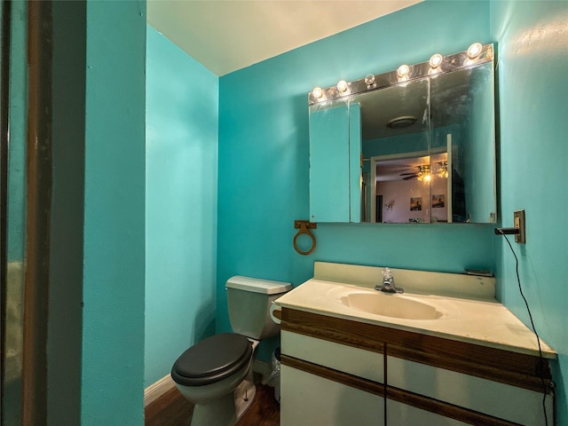 bathroom with vanity, hardwood / wood-style floors, and toilet