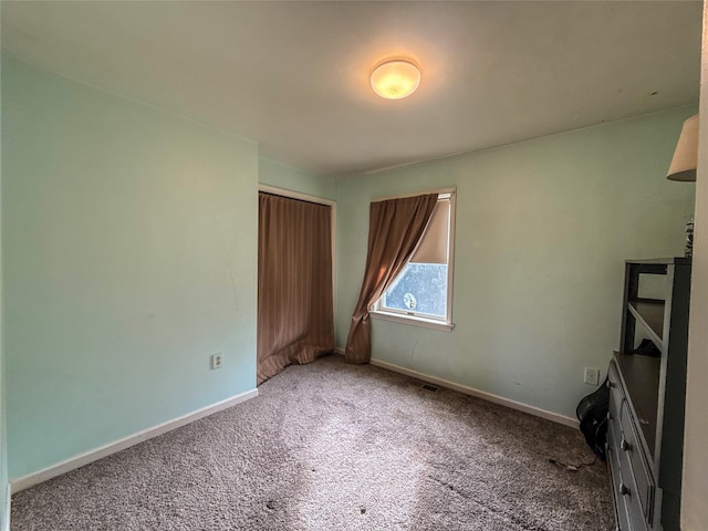 unfurnished bedroom with carpet and a closet