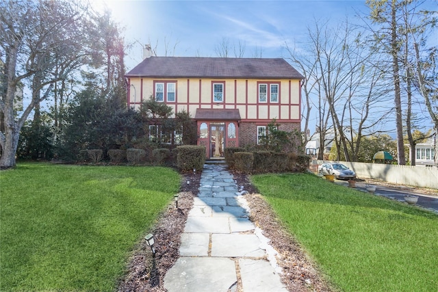 tudor home featuring a front yard