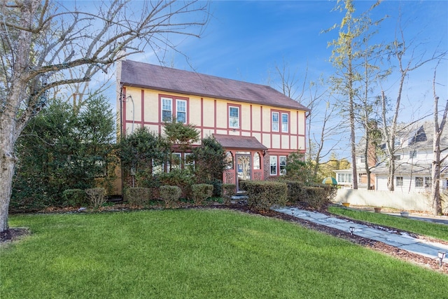 tudor house featuring a front lawn