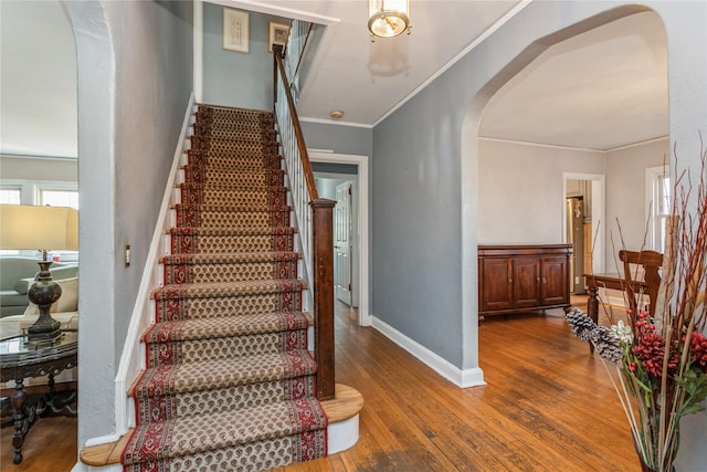 stairway featuring hardwood / wood-style flooring and ornamental molding