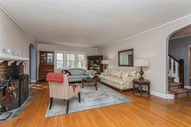 living room featuring hardwood / wood-style flooring and crown molding