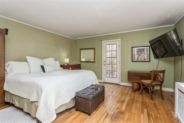 bedroom with ornamental molding and light hardwood / wood-style floors