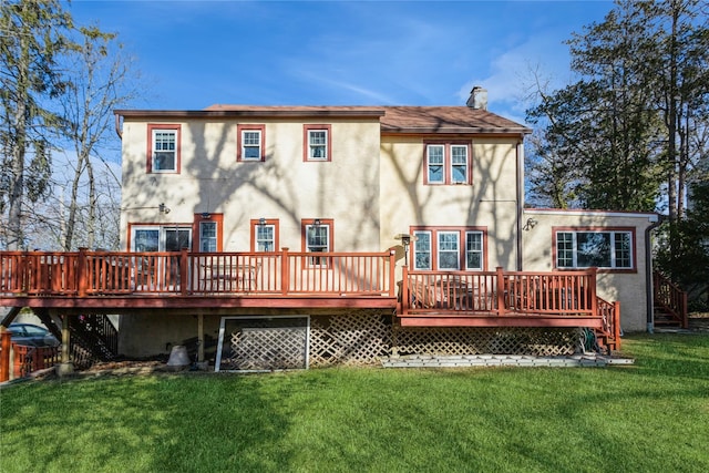 back of property featuring a deck and a lawn