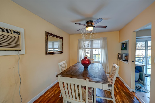 dining space with plenty of natural light, dark hardwood / wood-style floors, an AC wall unit, and ceiling fan