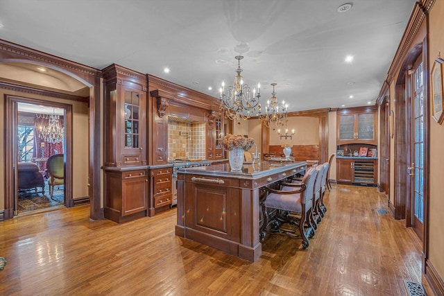 183 Mill Spring Rd, Manhasset, NY 11030 - interior space featuring recessed lighting, beverage cooler, ornamental molding, a chandelier, and light wood-type flooring