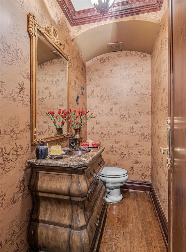 183 Mill Spring Rd, Manhasset, NY 11030 - half bath with toilet, wood finished floors, vanity, baseboards, and wallpapered walls