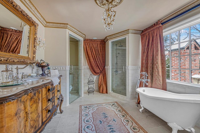 183 Mill Spring Rd, Manhasset, NY 11030 - full bathroom featuring a stall shower, tile walls, tile patterned floors, and wainscoting