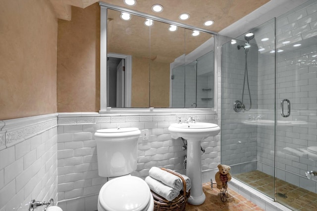 183 Mill Spring Rd, Manhasset, NY 11030 - full bathroom featuring recessed lighting, a stall shower, wainscoting, tile walls, and a sink