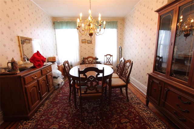 dining area with dark wood-type flooring, a chandelier, and a healthy amount of sunlight