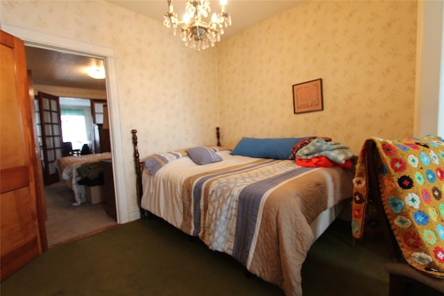 carpeted bedroom featuring an inviting chandelier