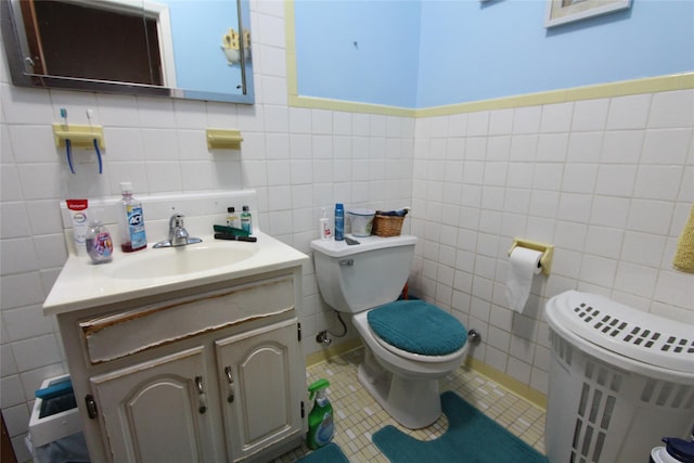 bathroom featuring radiator, tile walls, vanity, tile patterned floors, and toilet