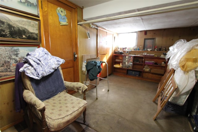 sitting room featuring wooden walls