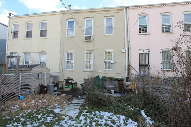 snow covered house featuring cooling unit and central air condition unit