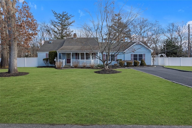 single story home with a porch and a front lawn