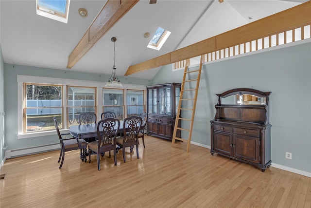 dining space with beam ceiling, a skylight, high vaulted ceiling, a baseboard radiator, and light wood-type flooring