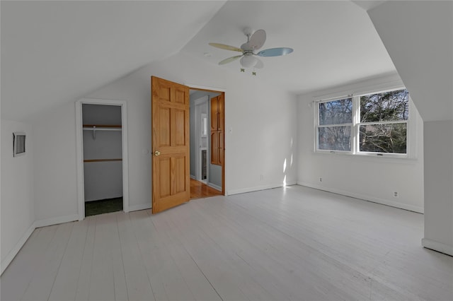 additional living space with lofted ceiling, ceiling fan, and light wood-type flooring