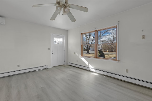 entrance foyer featuring a baseboard radiator, ceiling fan, and light wood-type flooring