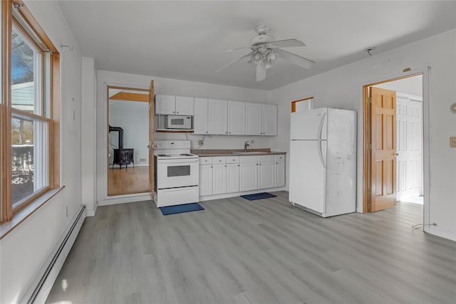 kitchen featuring sink, white cabinetry, light wood-type flooring, a baseboard radiator, and white appliances