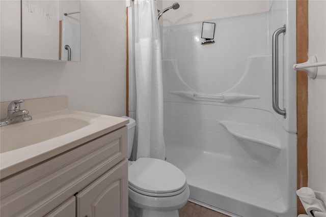 bathroom featuring vanity, curtained shower, and toilet