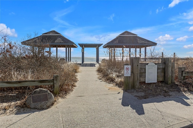 surrounding community featuring a water view and a gazebo