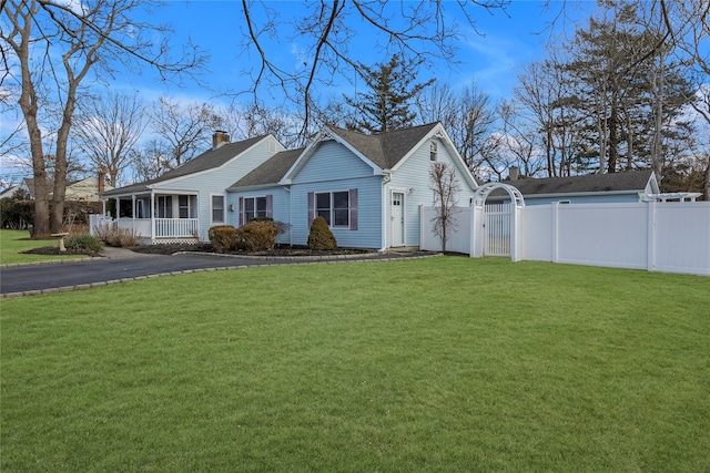 ranch-style house with covered porch and a front lawn