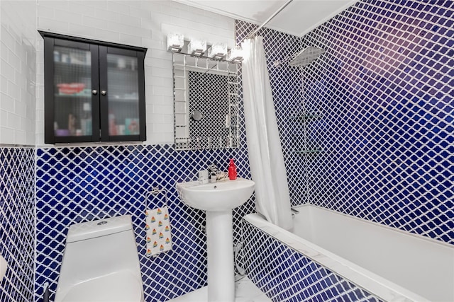 bathroom with tile walls, shower / tub combo with curtain, and toilet