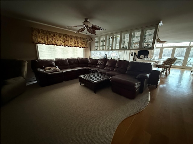 living room featuring hardwood / wood-style floors, a baseboard radiator, and ceiling fan