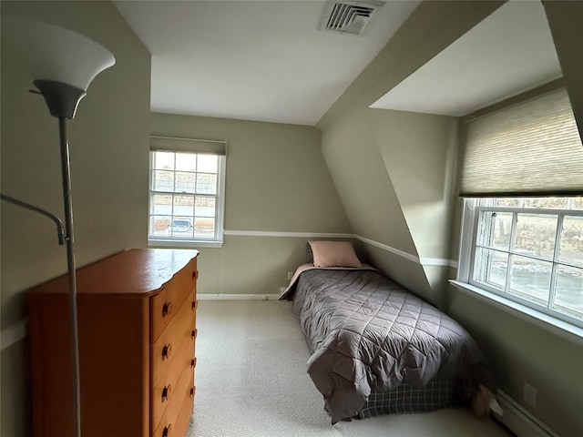 bedroom featuring lofted ceiling, light colored carpet, and baseboard heating