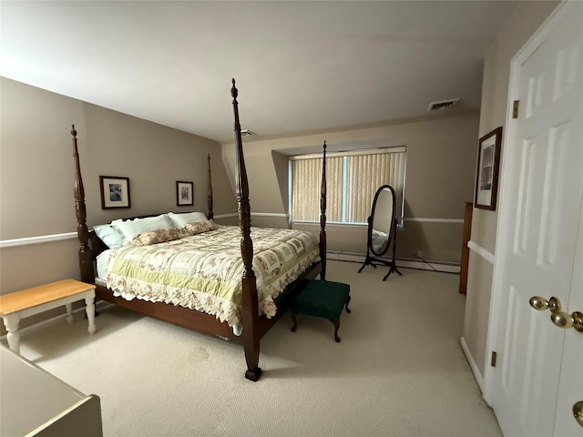 carpeted bedroom with a baseboard heating unit