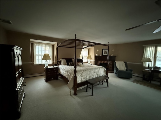 bedroom featuring ceiling fan, a baseboard radiator, and carpet