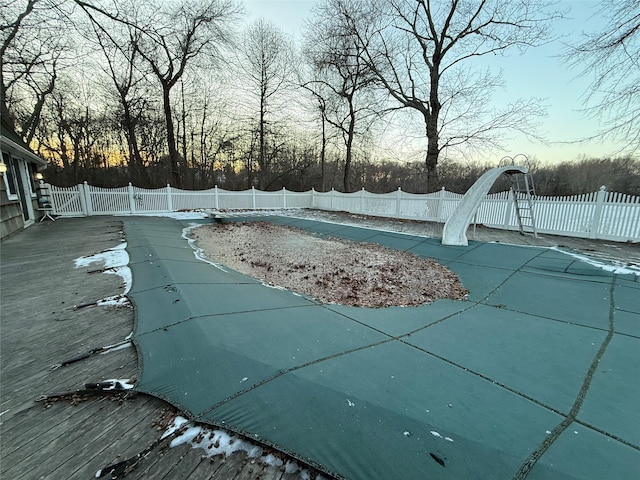 view of pool at dusk