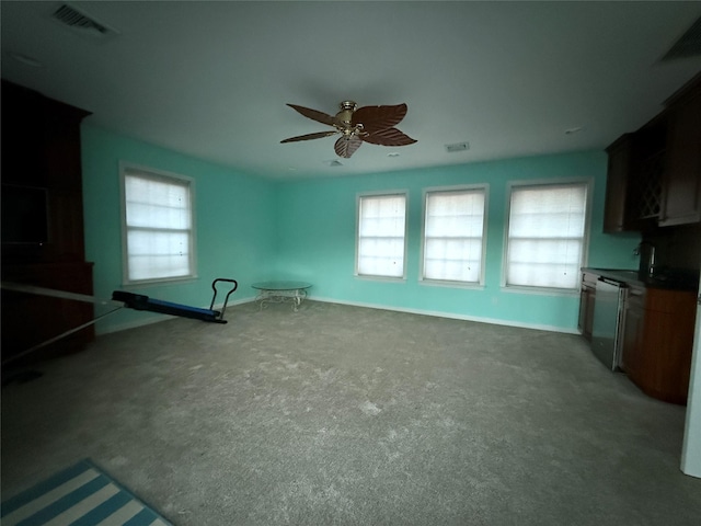 interior space with carpet flooring and ceiling fan