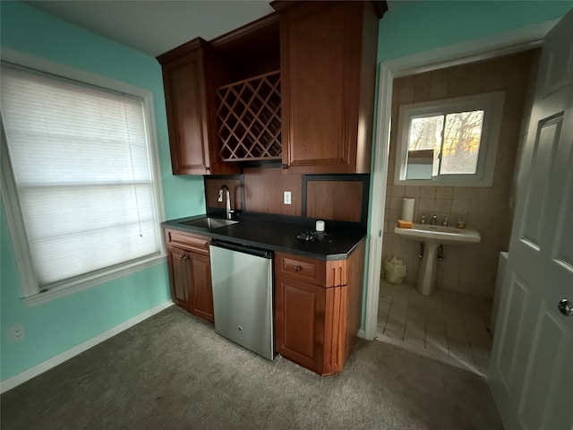 bar featuring tile walls, sink, and dishwasher