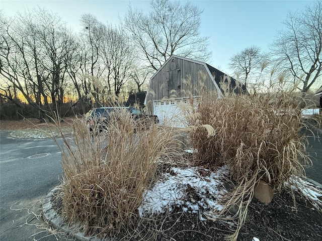 exterior space featuring a garage and an outdoor structure