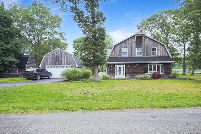 1 Lake Dr, Middle Island, NY 11953 - view of front of property featuring a gambrel roof, a detached garage, an outdoor structure, and a front lawn