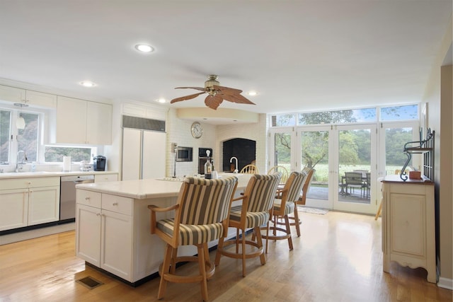 1 Lake Dr, Middle Island, NY 11953 - kitchen with stainless steel dishwasher, a ceiling fan, paneled fridge, healthy amount of natural light, and recessed lighting