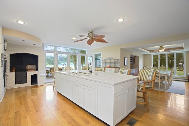 1 Lake Dr, Middle Island, NY 11953 - kitchen with a ceiling fan, white cabinetry, a center island, recessed lighting, and light wood-type flooring