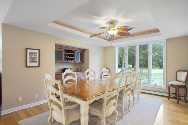 1 Lake Dr, Middle Island, NY 11953 - dining room with a raised ceiling, ceiling fan, light wood-style floors, and a baseboard radiator