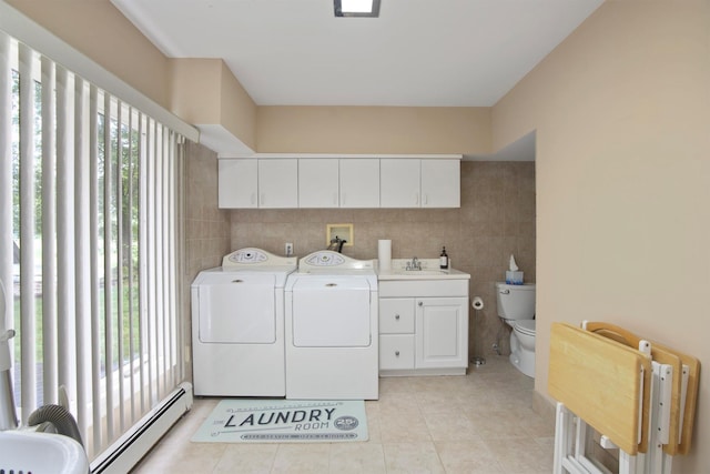 1 Lake Dr, Middle Island, NY 11953 - laundry area featuring a baseboard heating unit, separate washer and dryer, healthy amount of natural light, tile walls, and light tile patterned floors