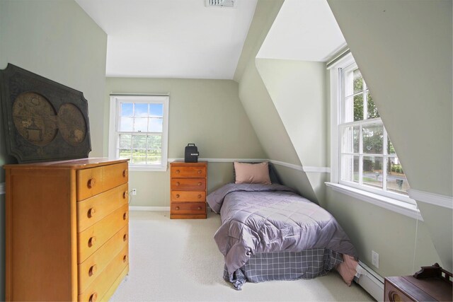 1 Lake Dr, Middle Island, NY 11953 - bedroom with multiple windows, baseboard heating, light carpet, and lofted ceiling