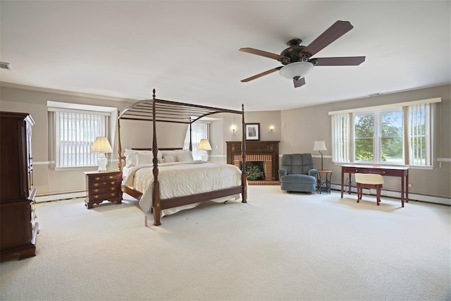 1 Lake Dr, Middle Island, NY 11953 - carpeted bedroom featuring baseboard heating, a brick fireplace, and a ceiling fan