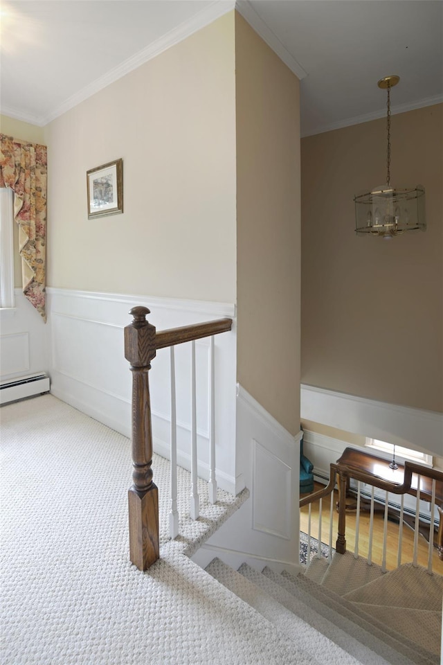 1 Lake Dr, Middle Island, NY 11953 - staircase with ornamental molding, a wainscoted wall, carpet floors, and baseboard heating