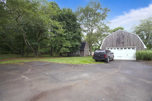 1 Lake Dr, Middle Island, NY 11953 - view of side of property with a gambrel roof, a detached garage, an outdoor structure, a lawn, and a barn