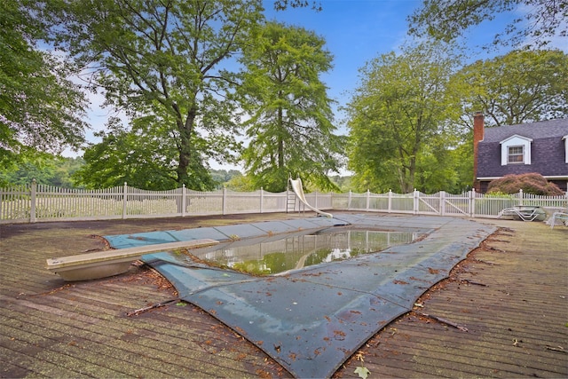1 Lake Dr, Middle Island, NY 11953 - view of swimming pool featuring a deck, a fenced backyard, and a water slide